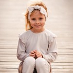Beige cotton blouse with ruffles on shoulders