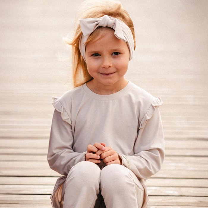 Beige cotton blouse with ruffles on shoulders