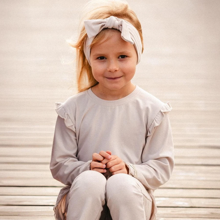 Beige cotton blouse with ruffles on shoulders