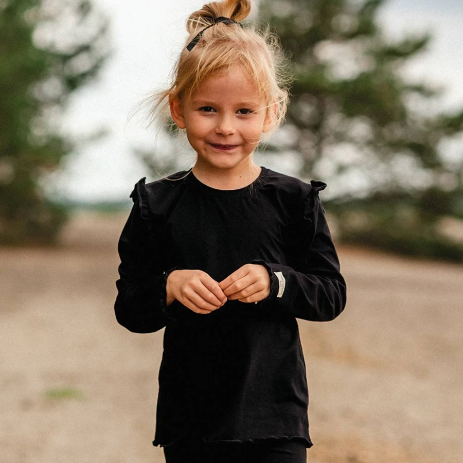 Black cotton blouse with ruffles on shoulders
