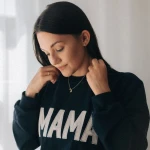 Navy blue sweatshirt with beige "MAMA" embroidery