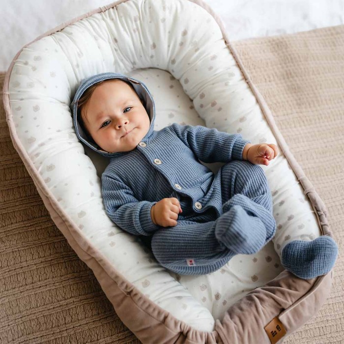 Blue knitted baby romper with hood