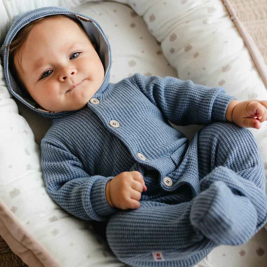 Blue knitted baby romper with hood