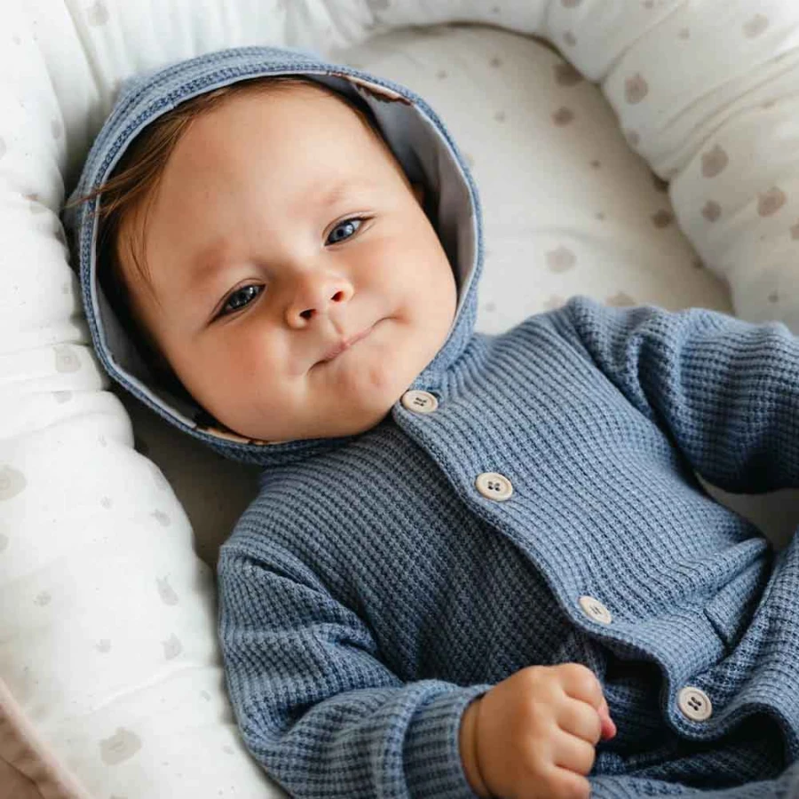 Blue knitted baby romper with hood