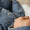 Blue knitted baby romper with hood